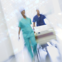 A blurred photo of a doctor and nurse rushing through a hallway